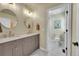 Elegant bathroom featuring double sinks, marble countertops, and stylish tile flooring at 3311 Klondike Pl, Castle Rock, CO 80108