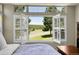 Inviting bedroom with picturesque views of lush greenery and serene landscapes from the windows at 3311 Klondike Pl, Castle Rock, CO 80108