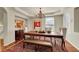 Charming dining room with a large wooden table, elegant chandelier, and stylish decor at 3311 Klondike Pl, Castle Rock, CO 80108