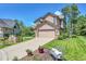 Well-maintained home exterior with a bench and colorful flower pots on a manicured lawn at 3311 Klondike Pl, Castle Rock, CO 80108