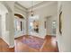 Elegant foyer with hardwood floors, high ceilings, and an arched doorway to the office at 3311 Klondike Pl, Castle Rock, CO 80108