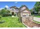 Inviting home exterior with stone accents, lush lawn, and charming water feature at 3311 Klondike Pl, Castle Rock, CO 80108