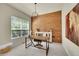 Bright home office featuring wood accent wall, modern desk, and ample natural light at 3311 Klondike Pl, Castle Rock, CO 80108