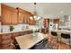 Eat-in kitchen featuring wood cabinets, stainless appliances, and a stone breakfast bar for casual dining at 3311 Klondike Pl, Castle Rock, CO 80108
