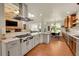 Gourmet kitchen with stainless steel appliances, stone countertops, and a cozy living area nearby at 3311 Klondike Pl, Castle Rock, CO 80108