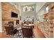 Stunning living room with stone fireplace, high ceilings, and abundant natural light at 3311 Klondike Pl, Castle Rock, CO 80108