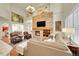 Spacious living room with stone fireplace, comfortable seating, and elegant decor at 3311 Klondike Pl, Castle Rock, CO 80108