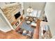 Living room featuring a stone fireplace, large windows, and comfortable seating arrangement at 3311 Klondike Pl, Castle Rock, CO 80108