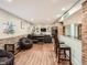 Finished basement area with a bar, exposed brick, and comfortable seating at 325 S High St, Denver, CO 80209