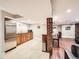 Basement area with a kitchenette featuring stainless steel appliances and a breakfast bar at 325 S High St, Denver, CO 80209