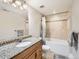 Well-lit bathroom featuring tile accents, a bathtub and a wooden vanity with granite counter at 325 S High St, Denver, CO 80209
