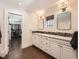 Elegant bathroom vanity with dual sinks, white cabinetry, and a view into the walk-in closet at 325 S High St, Denver, CO 80209
