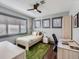 Comfortable bedroom with a green rug, plenty of natural light, and a ceiling fan for added comfort at 325 S High St, Denver, CO 80209