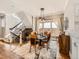 Elegant dining room with a modern chandelier, large window, and staircase at 325 S High St, Denver, CO 80209