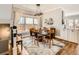 Elegant dining room with a modern chandelier, large window, and adjacent to the kitchen at 325 S High St, Denver, CO 80209