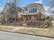 Attractive two-story home featuring a mix of brick and stucco, a small balcony, and mature landscaping at 325 S High St, Denver, CO 80209