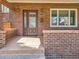 Charming brick home featuring a glass-paneled front door and a neatly maintained porch at 325 S High St, Denver, CO 80209