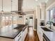 Bright kitchen features a center island, stainless steel appliances, hardwood floors, and access to an outdoor area at 325 S High St, Denver, CO 80209