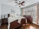 Comfortable main bedroom with hardwood floors, a ceiling fan, and natural light from the windows at 325 S High St, Denver, CO 80209