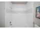 Clean bathroom with white tile, shower/tub combo, and mosaic accents at 6436 Silver Mesa Dr # E, Highlands Ranch, CO 80130
