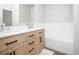 Modern bathroom with double vanity and light wood cabinets at 6436 Silver Mesa Dr # E, Highlands Ranch, CO 80130