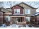 Brick townhouse exterior with a covered entryway and landscaping at 6436 Silver Mesa Dr # E, Highlands Ranch, CO 80130