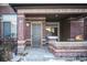 Townhouse entrance with gray door and brick facade at 6436 Silver Mesa Dr # E, Highlands Ranch, CO 80130