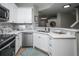Modern kitchen with white cabinets, stainless steel appliances, and a large island at 6436 Silver Mesa Dr # E, Highlands Ranch, CO 80130