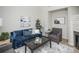 Living room with blue sofa and modern coffee table at 6436 Silver Mesa Dr # E, Highlands Ranch, CO 80130