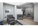 Living room with fireplace separating it from dining area at 6436 Silver Mesa Dr # E, Highlands Ranch, CO 80130