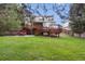 Large backyard with tiered wooden deck and patio with outdoor seating at 10375 Lions Heart, Lone Tree, CO 80124
