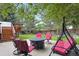 Backyard seating area with patio furniture set, tree house and patio swing at 10375 Lions Heart, Lone Tree, CO 80124