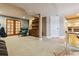 Finished basement with carpeted floors, wooden built-ins, and french doors leading to a seating area at 10375 Lions Heart, Lone Tree, CO 80124