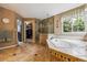 Well-appointed bathroom with shower, jacuzzi tub, and walk-in closet access at 10375 Lions Heart, Lone Tree, CO 80124