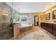 Luxurious bathroom featuring a shower, soaking tub, and double vanity at 10375 Lions Heart, Lone Tree, CO 80124