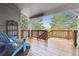 Covered deck with wooden flooring, blue chairs, and overhead lighting at 10375 Lions Heart, Lone Tree, CO 80124