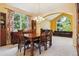 Cozy dining room with large windows, wood table, and an adjacent living area at 10375 Lions Heart, Lone Tree, CO 80124