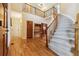 Grand foyer featuring hardwood floors, a curved staircase, and a second-floor balcony at 10375 Lions Heart, Lone Tree, CO 80124