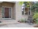 Inviting front porch with brick facade, large window, and outdoor seating at 10375 Lions Heart, Lone Tree, CO 80124