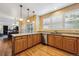 Open kitchen with stone countertops, wood cabinets, stainless steel appliances, and hardwood flooring at 10375 Lions Heart, Lone Tree, CO 80124