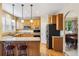 Well-equipped kitchen featuring stainless steel appliances, a breakfast bar, and wooden cabinetry at 10375 Lions Heart, Lone Tree, CO 80124