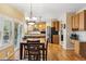 Open-concept kitchen with wood cabinets, stainless steel appliances, and an island with seating at 10375 Lions Heart, Lone Tree, CO 80124