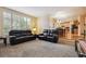 Comfortable living room with large window and modern leather sofas; great natural light at 10375 Lions Heart, Lone Tree, CO 80124