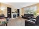 Comfortable living room featuring a fireplace, built-in bookshelves, and ample seating at 10375 Lions Heart, Lone Tree, CO 80124