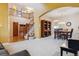 Open-concept living space with staircase, second-floor balcony, and adjacent dining area at 10375 Lions Heart, Lone Tree, CO 80124