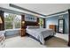 Spacious main bedroom featuring tray ceilings and large windows overlooking beautiful greenery at 10375 Lions Heart, Lone Tree, CO 80124
