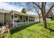Charming backyard featuring a covered patio, fenced yard, and lush green lawn at 33 Canongate Ln, Highlands Ranch, CO 80130