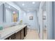 Bright bathroom boasts a modern vanity, neutral tile, and a large mirror for ample lighting at 33 Canongate Ln, Highlands Ranch, CO 80130