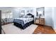 Cozy bedroom features a plush rug, wood floors, and blue accents for a relaxing retreat at 33 Canongate Ln, Highlands Ranch, CO 80130
