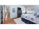 Comfortable bedroom with wood floors, a large window, and a view into the adjoining room at 33 Canongate Ln, Highlands Ranch, CO 80130